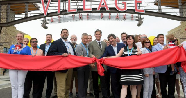 NewMark Merrill's Alan Ginsborg, center, and other VIPs prepare to cut the ribbon during the grand opening of Village at the Peaks shopping center Friday. The project, which started nearly six years ago, constitutes a $90 million investment. Lewis Geyer/Staff Photographer July 01, 2016
