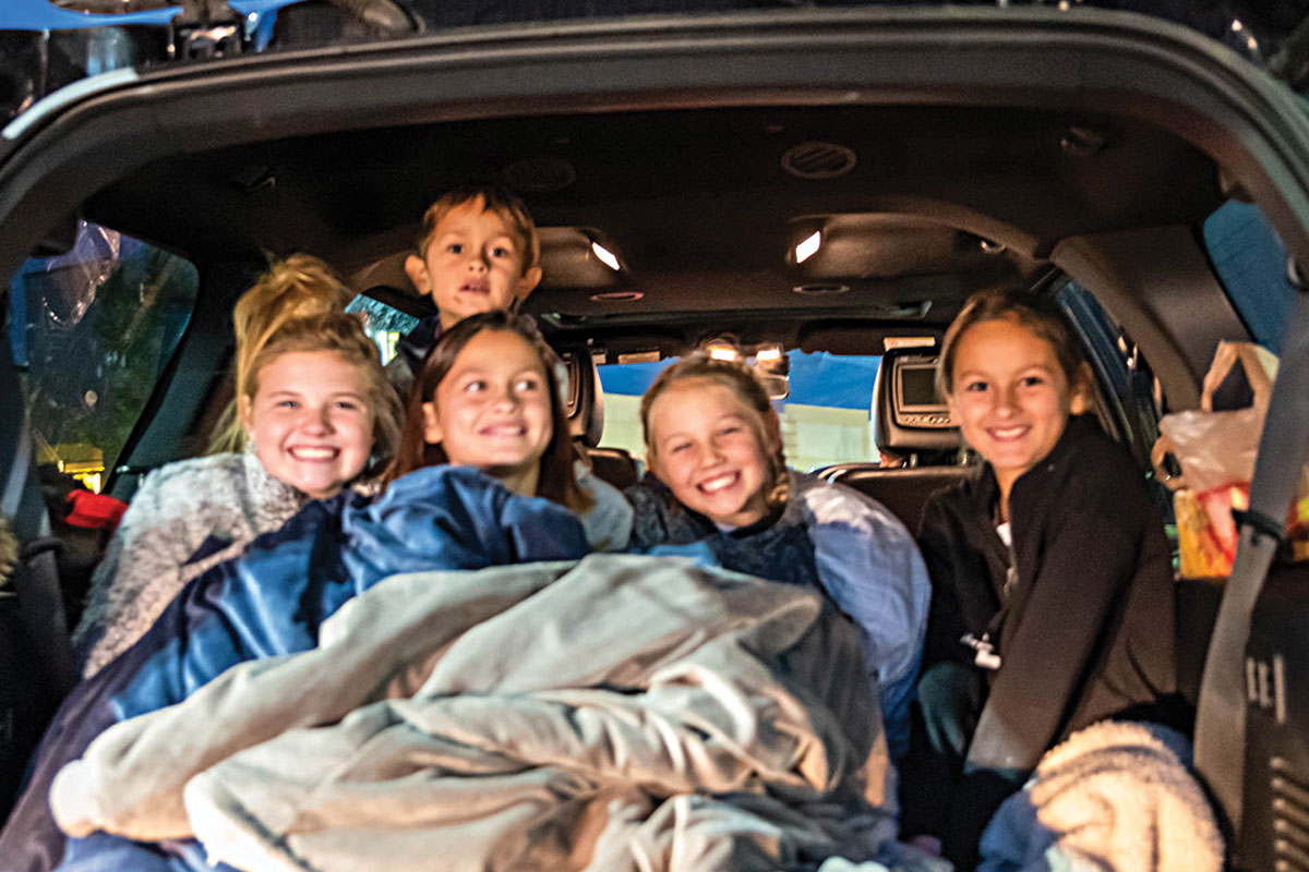 Group of kids in back of van for drive in movie