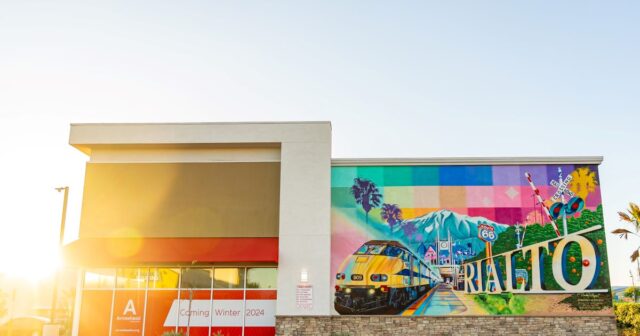 Arrowhead and mural of train and route 66 with mountain image at Rialto Village