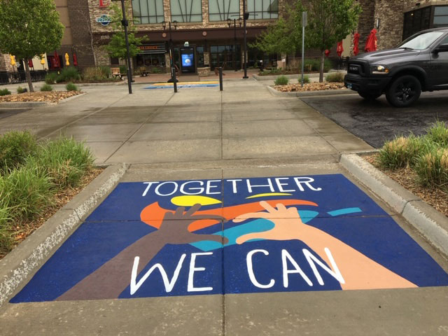 Together We Can artwork on sidewalk