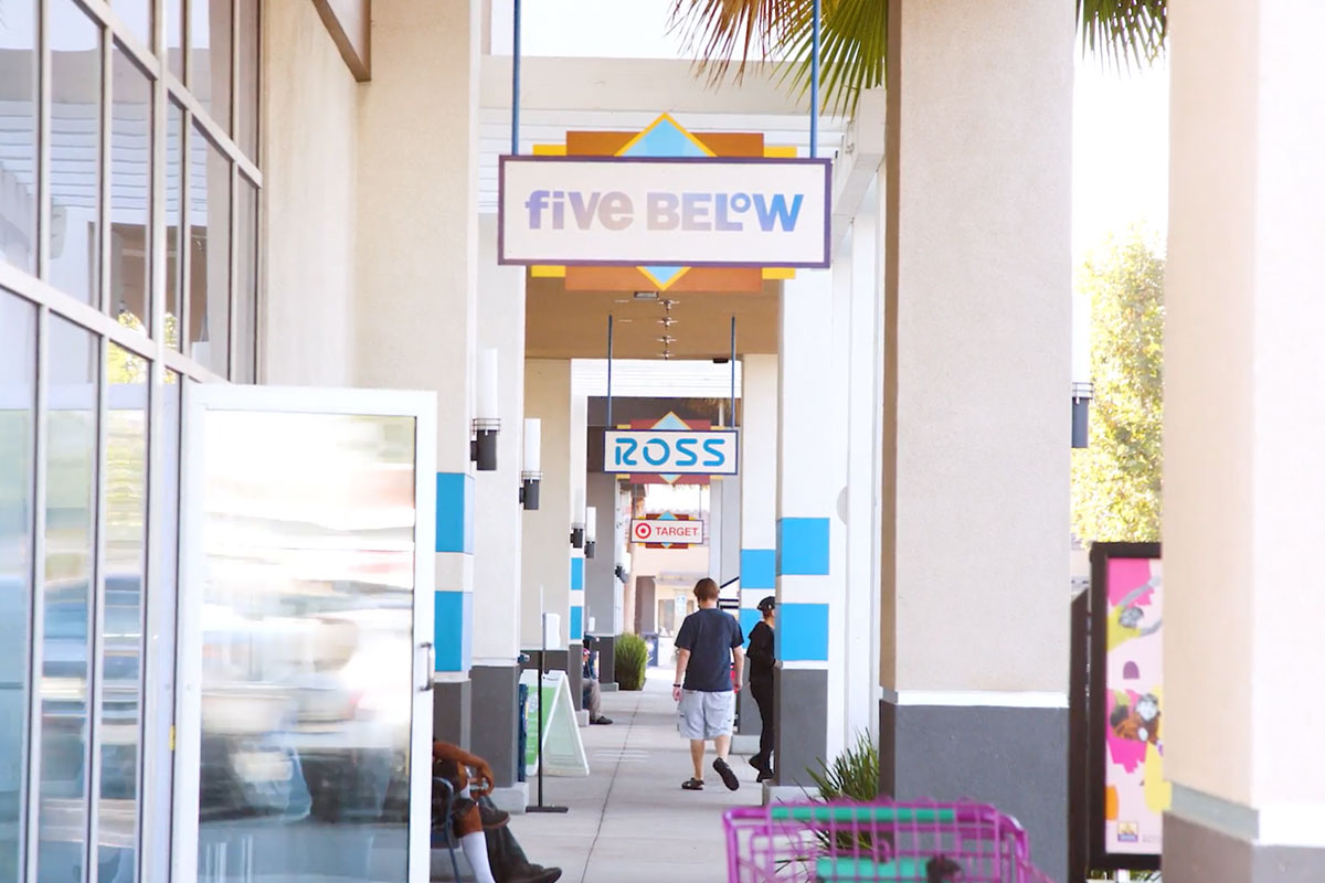 Shopping center walkway with signs for Five Below and Ross