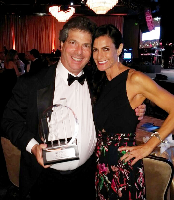 Sandy Sigal and Allison with Entrepreneur of the Year award
