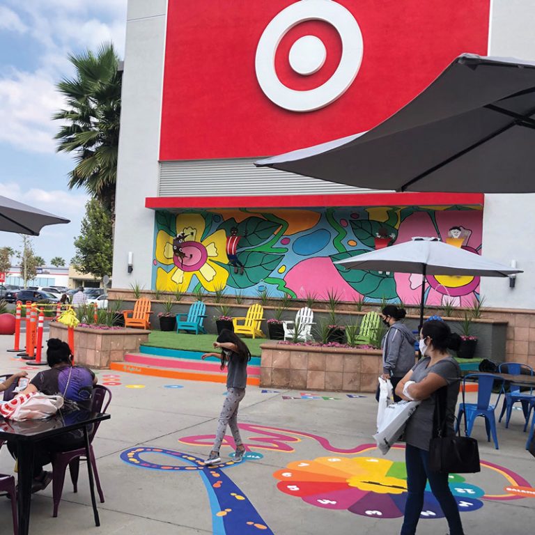 People interacting with mural on ground outside Target
