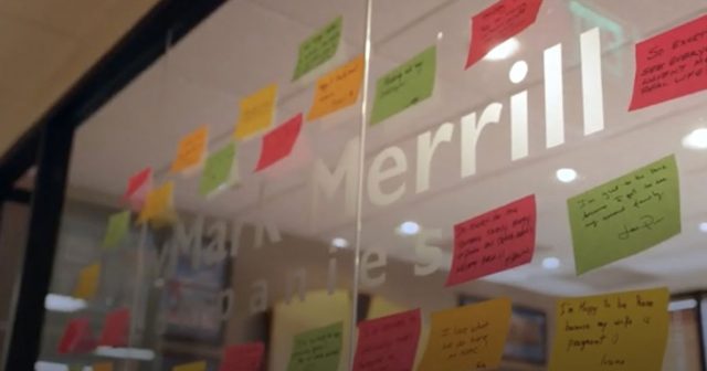 NewMark Merrill glass wall in office with post-it notes