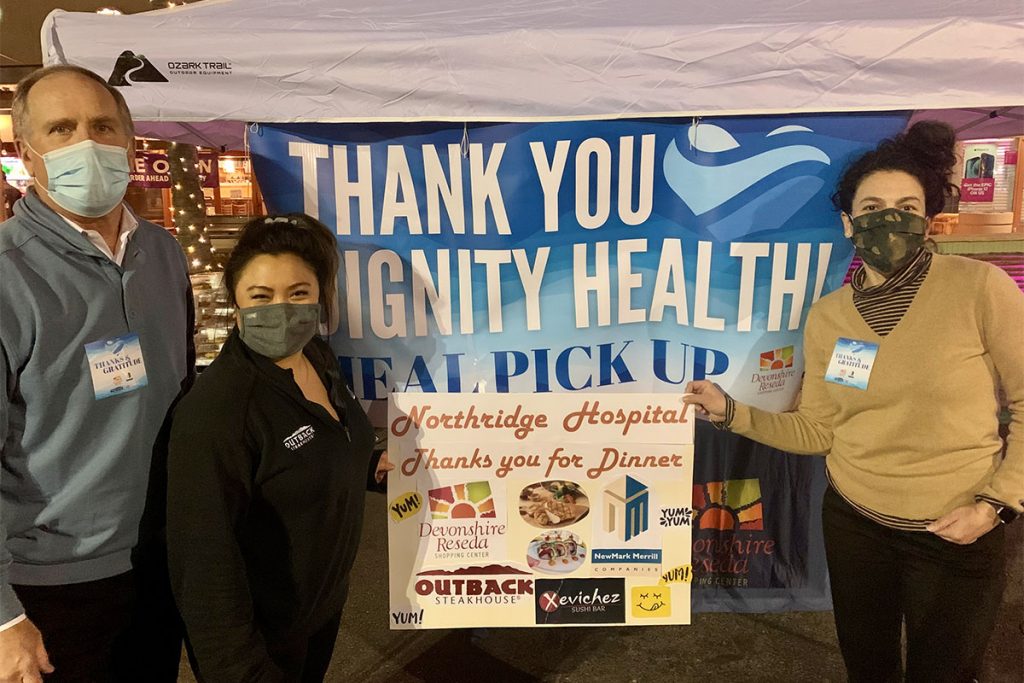 Staff standing in front of Thank You Dignity Health banner