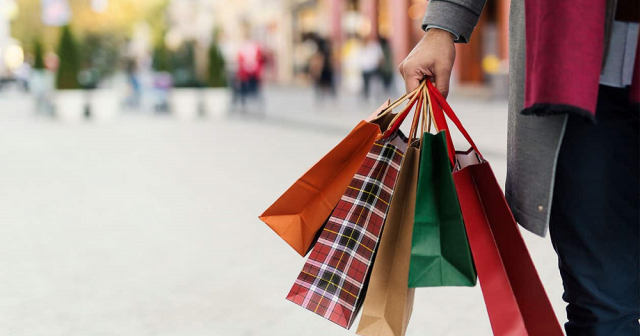 Man holding shopping bags with presents